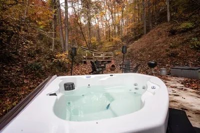 Hot tub in leaf season — 104 degrees with cold air on your face and gold in every direction. Ask any guest: this is the soak they remember.