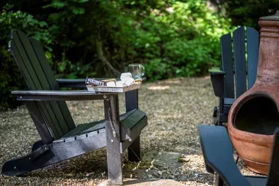 Two chairs, two mugs, and a chiminea waiting for a match. Mornings out here start slow and quiet, with birdsong and coffee and absolutely nowhere to be.