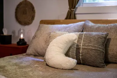 Layered linens, soft pillows, and a moon to sleep under even indoors. Every bed is made fresh — small touches, but they're the ones guests write about.