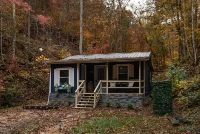 The cabin in fall, bare woods opening up the views you can't see in summer. Colder nights, better stars, and the wood stove ready the second you walk in.