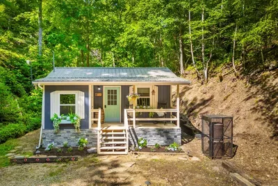 Your own cabin tucked into the hillside, porch lights on and no one else in sight. Park, climb the steps, and feel the week fall away before you've even opened the door.