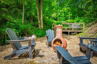 Chiminea crackling, chairs circled, woods going dark around you. Firewood's on site — all you need is a lighter and a reason to stay up later than you planned.