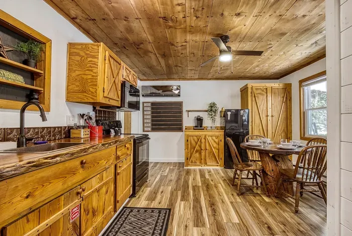 Live-edge counters, open shelving, and full-size appliances in a kitchen that's actually stocked. Pans, spices, the works — plan real meals, not just cereal.