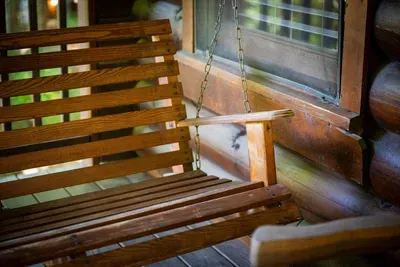 A porch swing that creaks in exactly the right way — slow arcs, cool air sliding down off the ridge, and no real reason to be anywhere else before dinner is called.