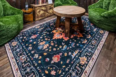 Oversized moss-green bean bags on a jewel-toned rug — the softest landing spot in the game room, and reliably claimed within minutes of every single check-in.