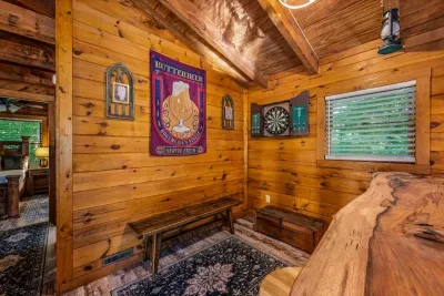 Steel-tip darts, pub signage, and a window into the woods — this is the after-dinner corner, where the competition gets serious and nobody thinks to check their phone.