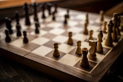 A weighted wooden chess set waiting mid-game on the sideboard. No screens required — rivalries start here, carry straight through dinner, and last until the drive home.