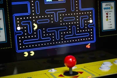 A retro arcade cabinet glows in the game room corner — classic maze-chase battles, rainy-afternoon tournaments, and bragging rights that last the entire trip. Press start