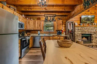 A fully equipped kitchen with stainless range, microwave, and full-size fridge — plus a thick-slab pine table for pancake mornings. Everything you need to skip the drive into town.