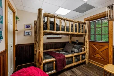 Two sets of hand-hewn log bunks sleep the whole crew of cousins — extra beds, extra room, and zero arguments about who's stuck sleeping on the living room couch.