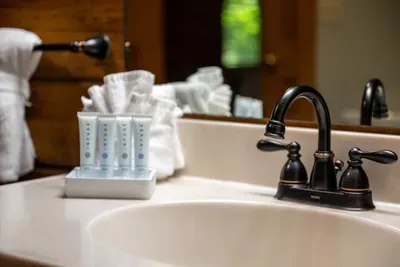 Toiletries lined up like potion vials, towels folded, bronze fixtures polished — the themed details reach all the way to the bathroom counter and the guest robes.