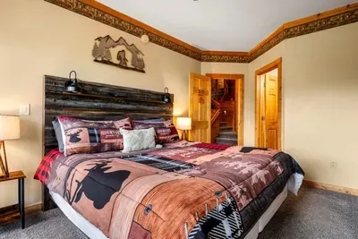 Welcome to your cozy retreat! Unwind in the comfortable king-sized bed in this private downstairs bedroom.