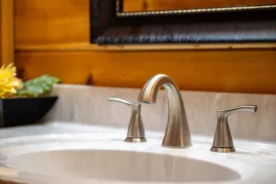 Brushed nickel fixtures on a clean granite top