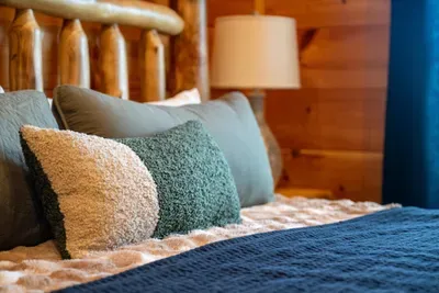 Layered pillows and a lamp on the nightstand