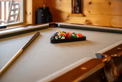 Pool table racked and waiting in the game room