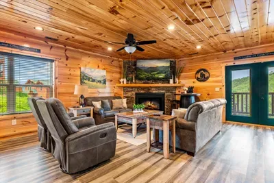 Recliners, sofas, and windows out to the treeline