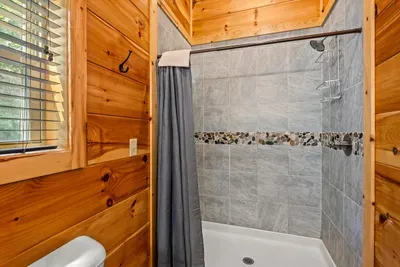 Tub-shower combo with tile surround and towels out