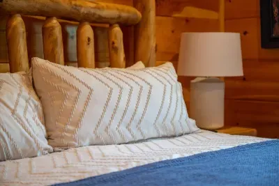Log headboard, soft pillows, warm lamplight