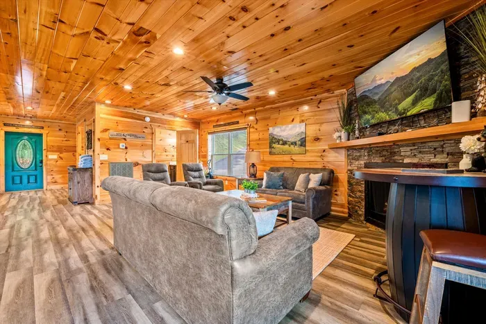 Stone fireplace, big TV, and room for everyone to sit