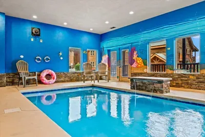 Indoor pool room with seating all around the water