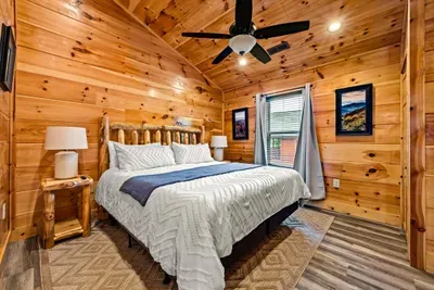 Vaulted pine ceiling over a bed made up fresh