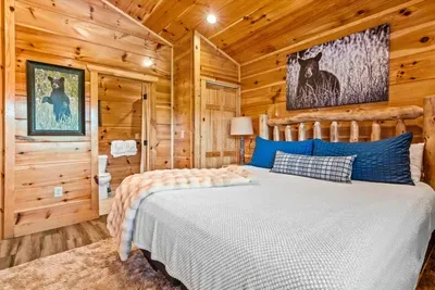 Framed art, blue pillows, and a bed turned down