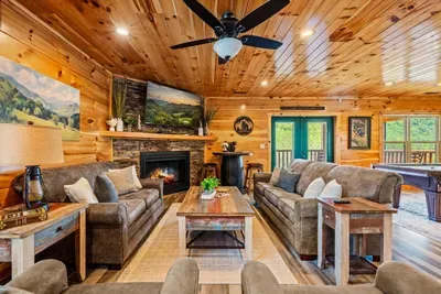 Two full sofas facing the fireplace and the screen