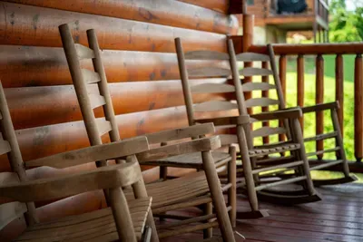 Rocking chairs lined up along the porch rail