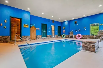 Indoor pool with a door straight out to the deck