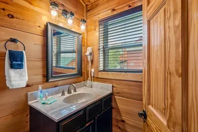 Full bath with a window and a wide counter