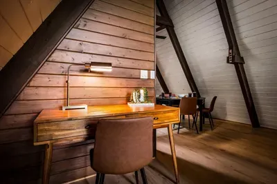 Dedicated work nook framed by warm wood and quiet — a real desk for the days you need to plug in. Get it done, then close the laptop and let the mountains take over.