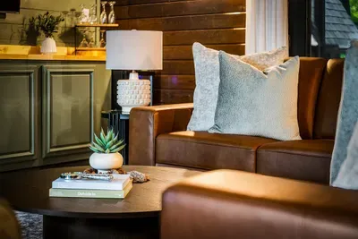 Buttery leather seating beside the bar, styled down to the last detail — pour a drink and sink in. This is where the crew lands once the sun's down.