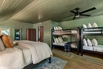 Kid-approved retreat with a plush queen and built-in bunks — everyone claims their own spot. Green shiplap and mountain quiet make lights-out the easy part.