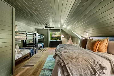 Family-friendly room pairing a queen bed with built-in bunks — everyone gets their own spot and the kids will fight to claim top bunk. Extra sleeping space, zero fuss.