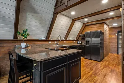 Chef's kitchen anchored by a granite island with prep space to spare and stainless appliances at the ready. Cook for a crowd while the conversation keeps flowing around you.
