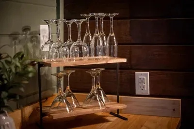 Glassware racked and the bar ready to pour — a proper wet bar for easy evenings in. Mix a drink, find a couch, and settle into cabin time.