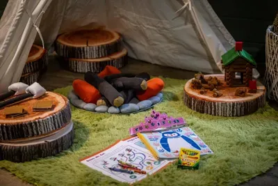 Storybook play nook with a make-believe campfire, coloring books, and cozy log seats — designed to keep little adventurers busy while the grown-ups unwind. A rare find in a Gatlinburg cabin.