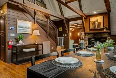Handcrafted dining table for the whole party, tucked beside warm wood paneling and the stone fireplace. Pull up a chair — this is where the trip's best conversations happen.