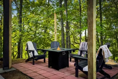 Gather 'round the gas fire pit as the woods go quiet — Adirondack chairs, warm blankets, and s'mores weather all year. The heart of every evening here.