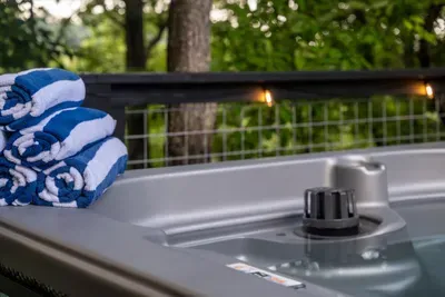 Fresh towels rolled and waiting by the hot tub — the little touches that mean you just climb in and let the day go. Nothing to do but relax.