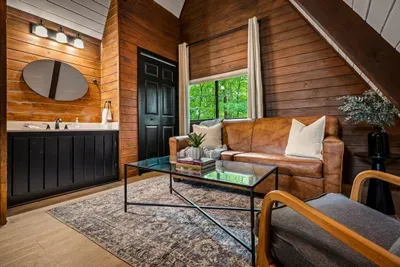 Ensuite that doubles as a retreat — private vanity, a leather loveseat, and a window to the trees. Get ready without the rush, then linger a little longer than you meant to.