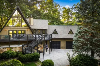 Iconic A-frame with sprawling wings and a multi-level deck, wrapped in mature forest. Big enough for the whole group, private enough to disappear for a week.