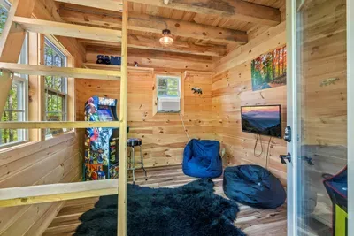Give the kids their own cabin retreat — complete with games, TV, and cozy beanbags.