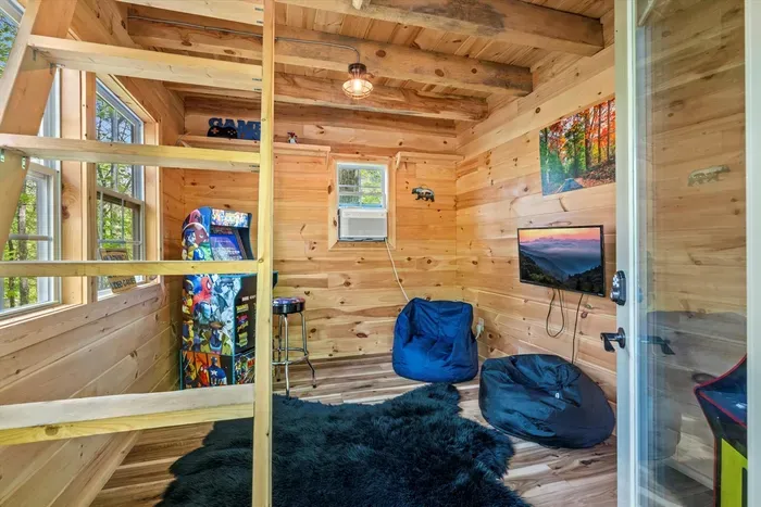 Give the kids their own cabin retreat — complete with games, TV, and cozy beanbags.