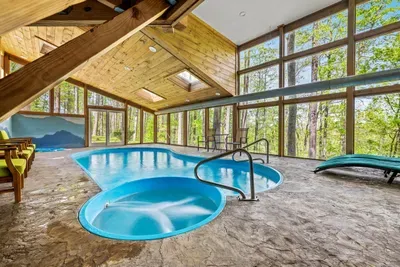 Soak, splash, and relax — indoor pool + spa overlooking the trees.