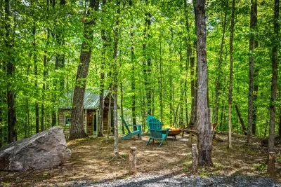 Kids will love the log playhouse while the adults relax fireside — fun for all ages in one magical spot.