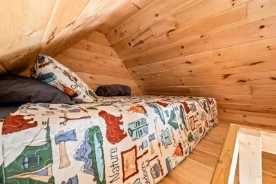 Bedroom 5 is located in the Game Shack (separate building away from the house).  This includes a queen bed!