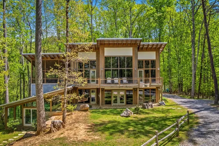 Stunning contemporary cabin — floor-to-ceiling glass and natural light throughout.