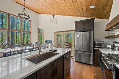 Fully equipped kitchen with a view of dining are and living room.