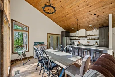 Dining area with a view of kitchen and living room.